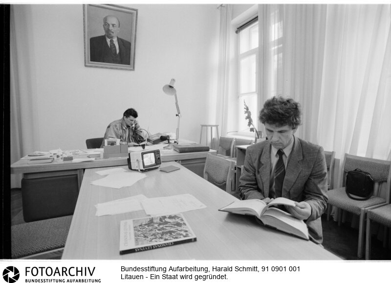 KGB-Auflöser sortieren Akten im ehemaligen Chefzimmer des KGB. Im Fernseher laufen Kinder-Cartoons. <BR>Aufnahmedatum: September 1991<BR>Material/Technik: Foto<BR>Aufnahmeort: Litauen<BR>Signatur: 91 0901 001