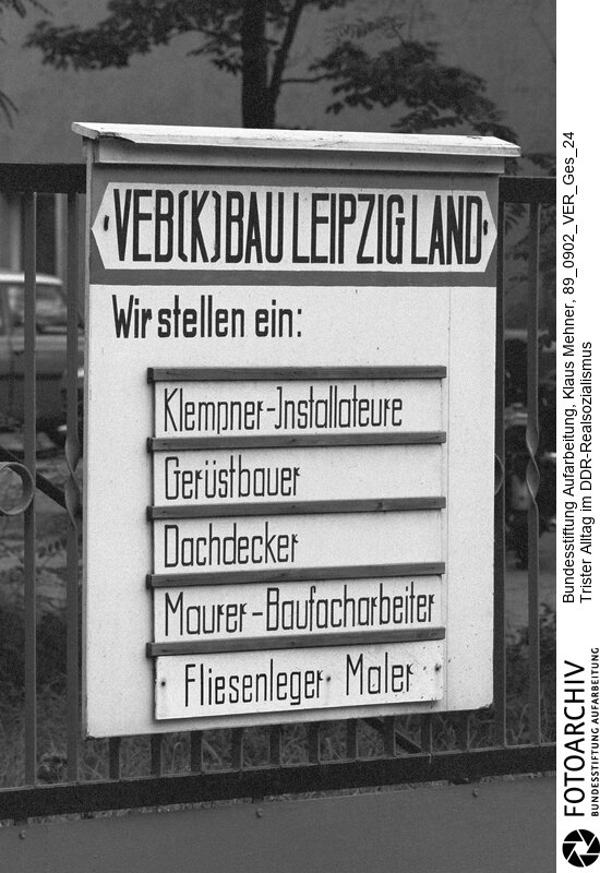 Leipzig (Bezirk Leipzig) DDR, 02-09-1989. Der Niedergang der Deutschen Demokratischen Republik (DDR) ist in allen Bereichen des öffentlichen Lebens manifest. Die zur Messe übliche bessere Versorgung mit Obst und Gemüse befriedigt die Bevölkerung nicht mehr. Funktionäre und Parteikader der Sozialistischen Einheitspartei Deutschland (SED) hat Verunsicherung erfasst. Foto: Arbeitskräftemangel im Baukombinat.<BR>Material/Technik: Foto<BR>Bezirk Leipzig<BR>Signatur: 89_0902_VER_Ges_24